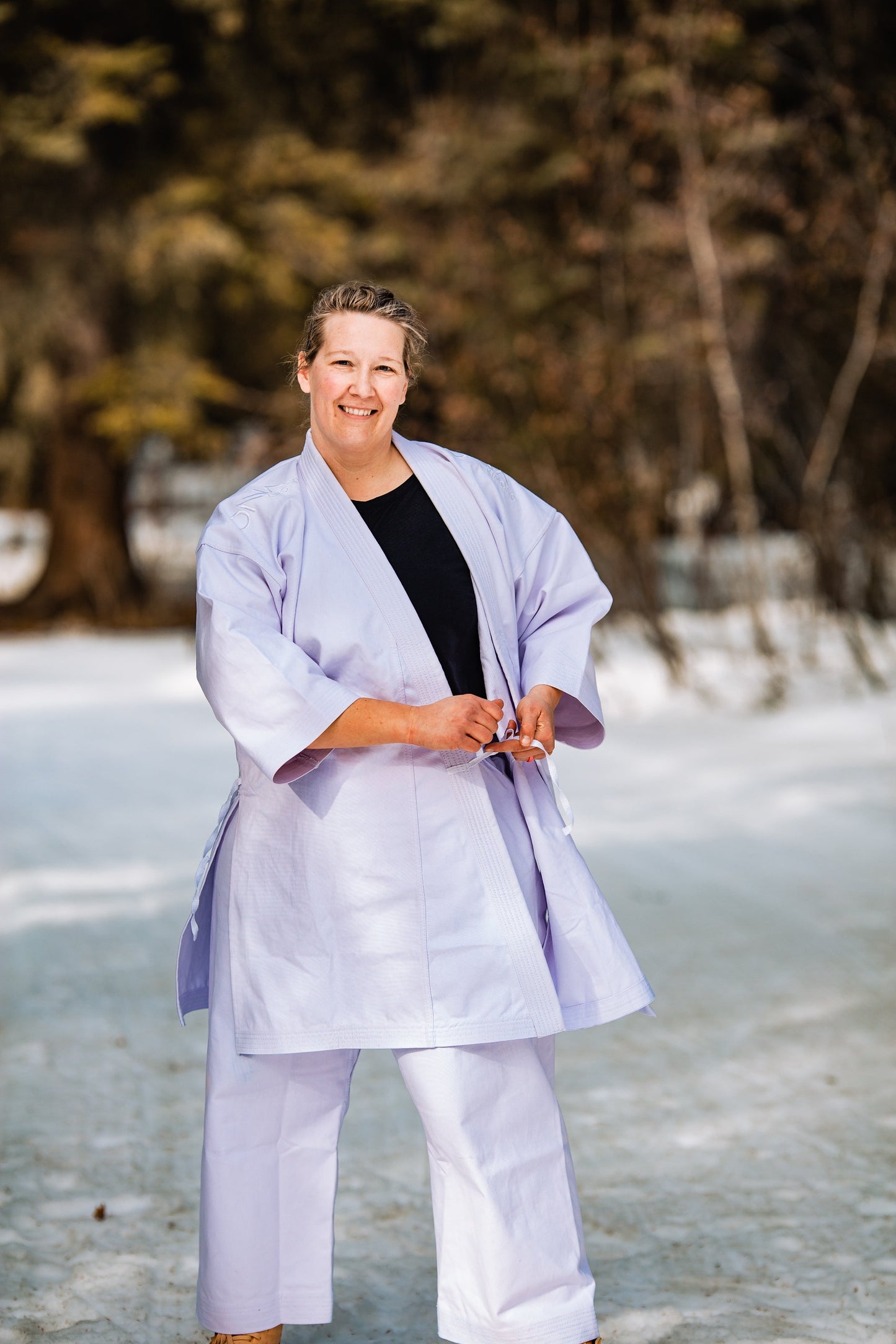 Woman tying her karate jacket at the side ties