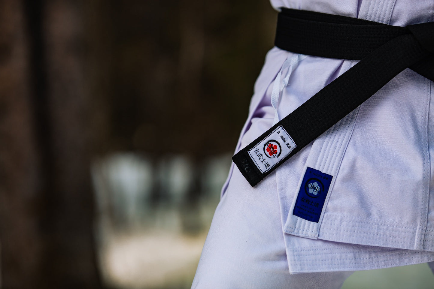 close up karate uniform and black belt labels