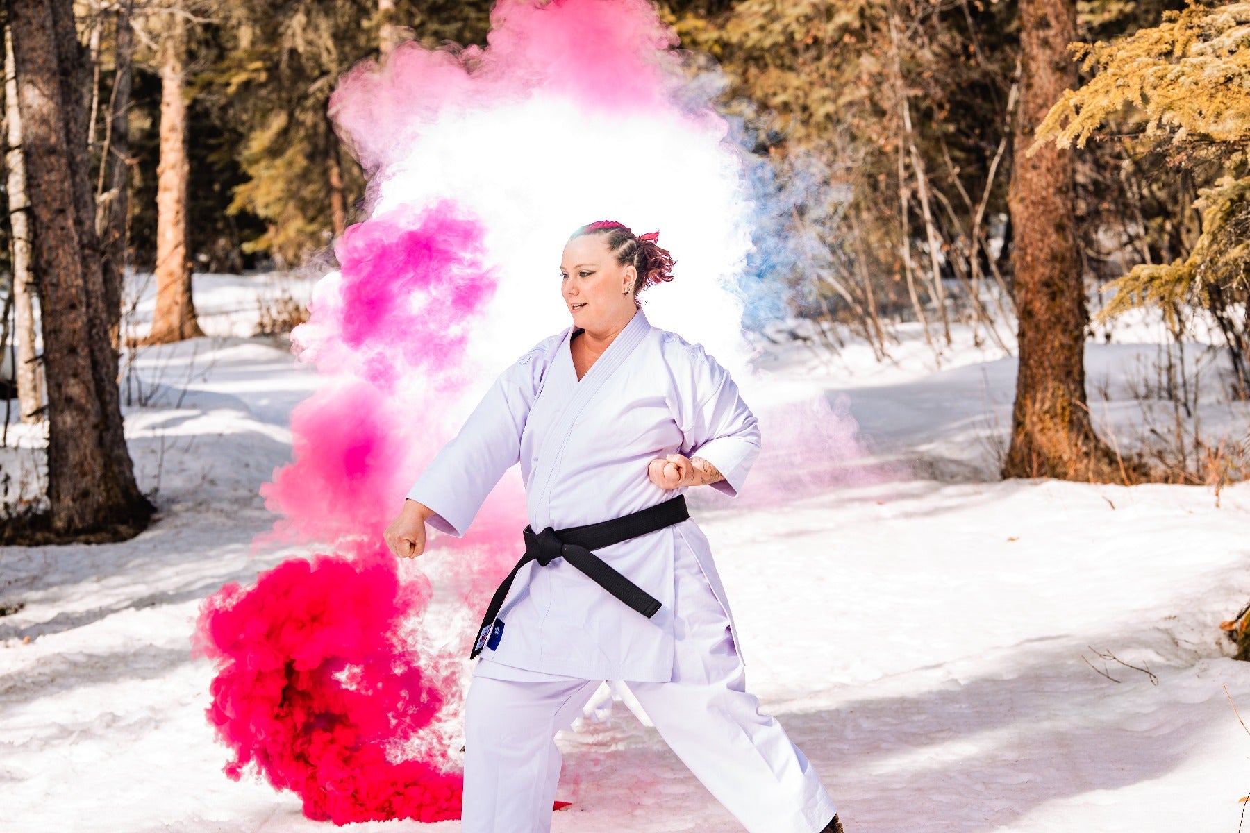 Woman in Karate gi with pink smoke and pink hair